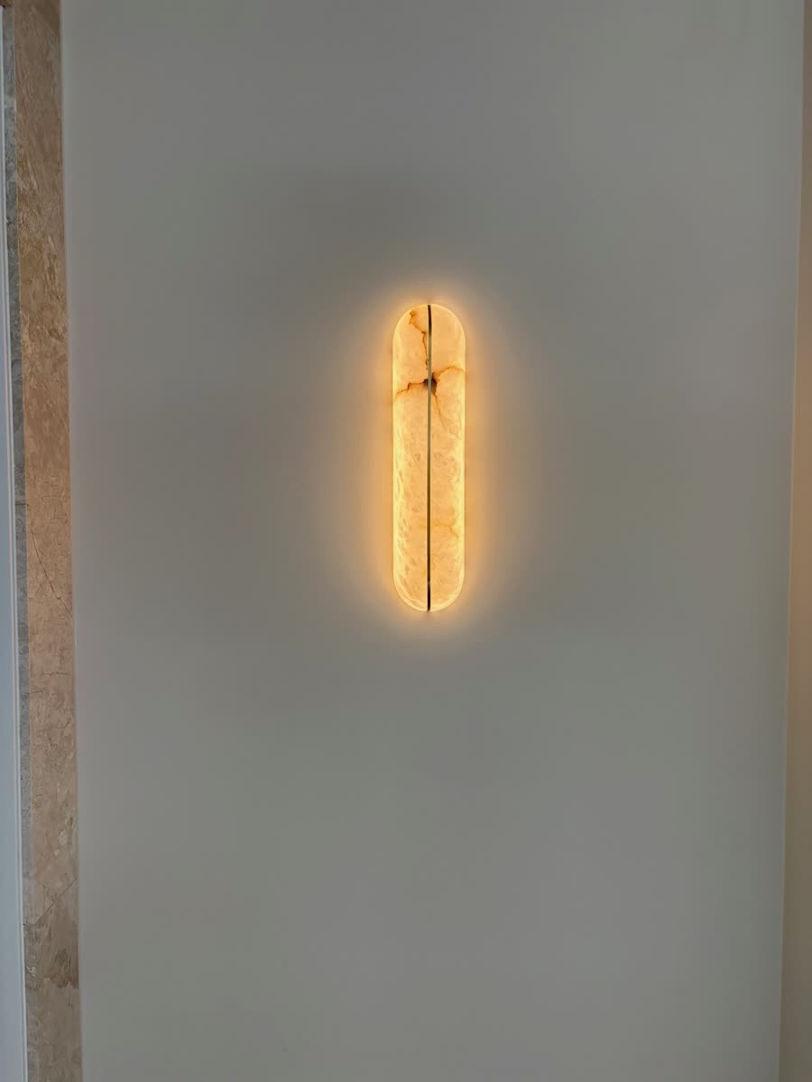 Wall sconce with warm-glowing marble face